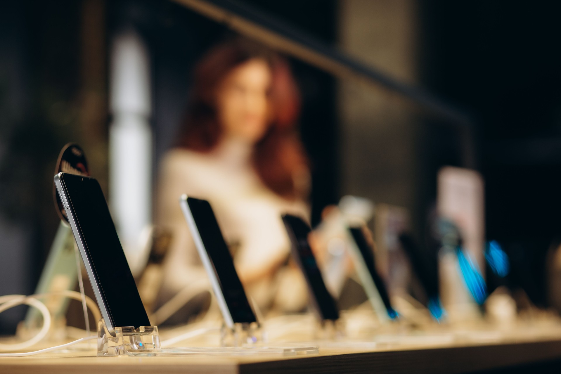 Smartphones store. Showcase with selling various new smartphones in electronics store during a sale. Mobile phone market concept