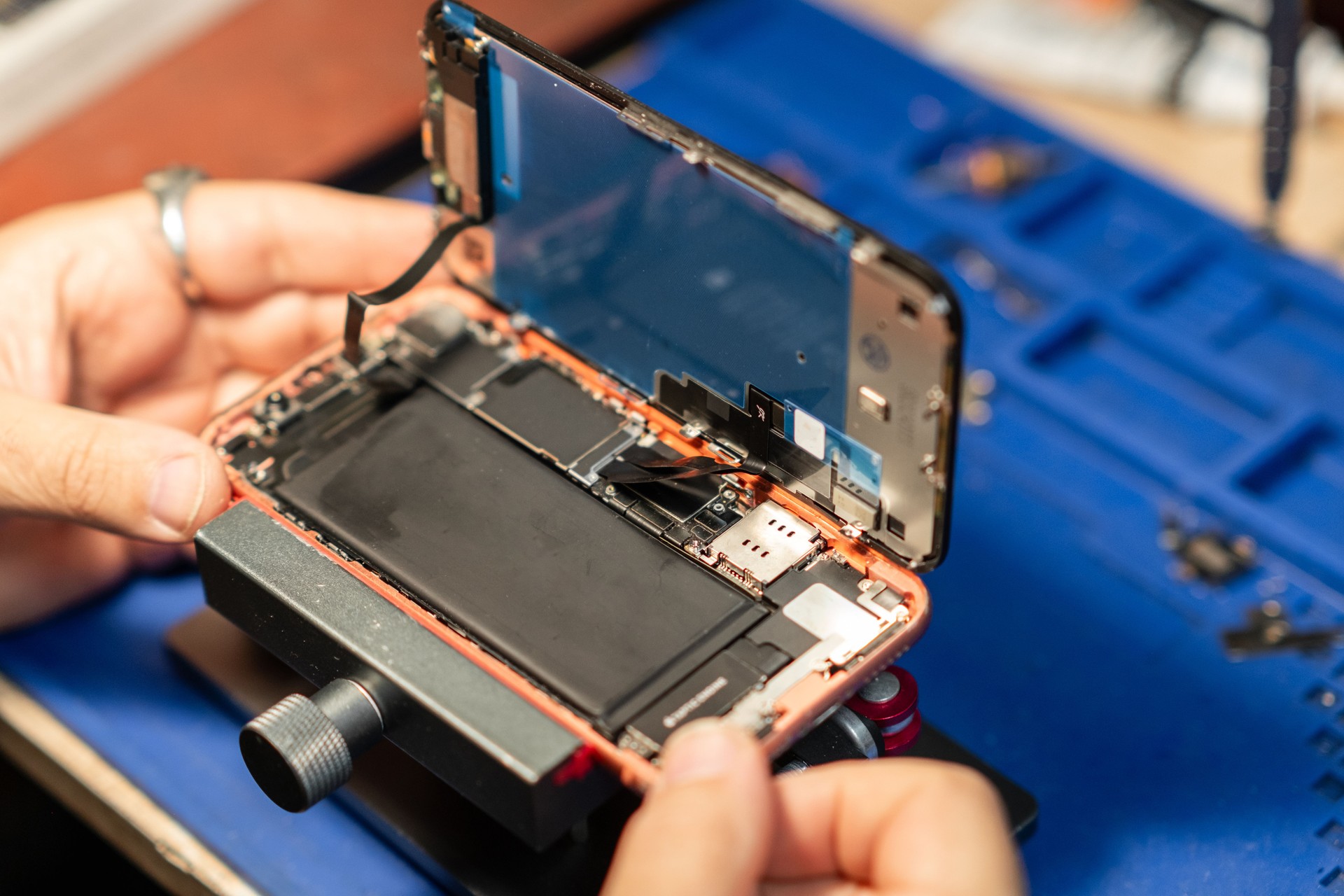 Smartphone Battery Repair In A Tech Shop Showing Detailed Disassembly And Replacement Process